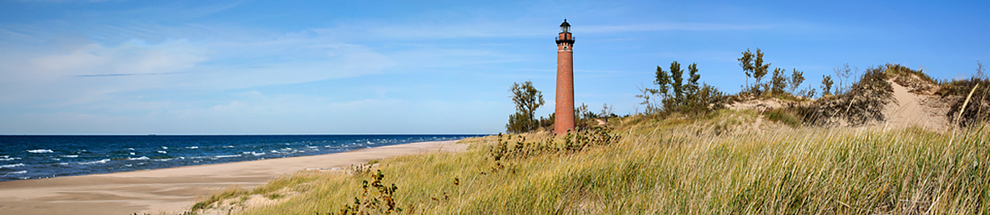 beach and lighthouse on lake michigan